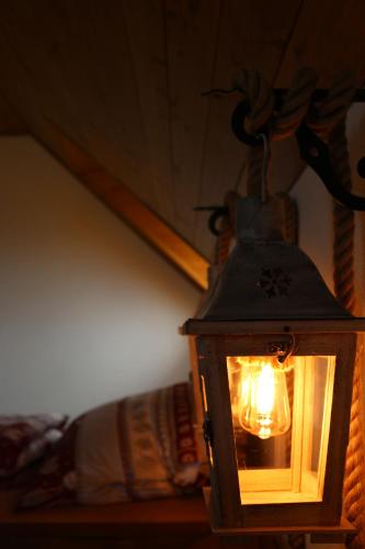 a lantern hanging from the ceiling of a room at Pinus Cembra in Stará Lesná