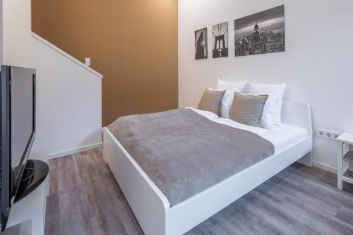 En eller flere senge i et værelse på Central Cozy Stay