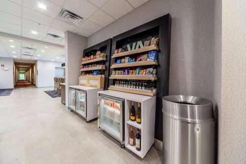 a room with several refrigerators and drinks on the wall at Hampton Inn Winchester in Winchester