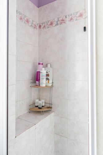 a bathroom with a shower with white tiles at Terra di Mezzo in Castellanza