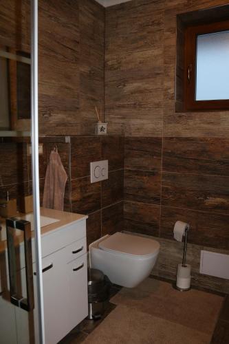 a bathroom with a toilet and a sink at Pinus Cembra in Stará Lesná