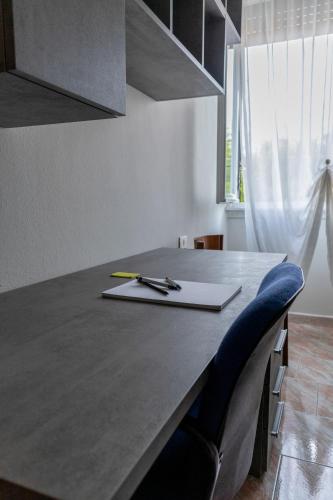 a kitchen counter with a desk with a pen on it at Terra di Mezzo in Castellanza