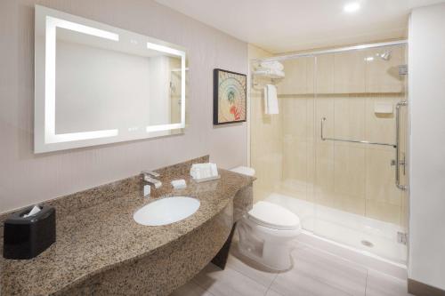 a bathroom with a sink and a toilet and a shower at Hilton Garden Inn Montreal Centre-Ville in Montreal