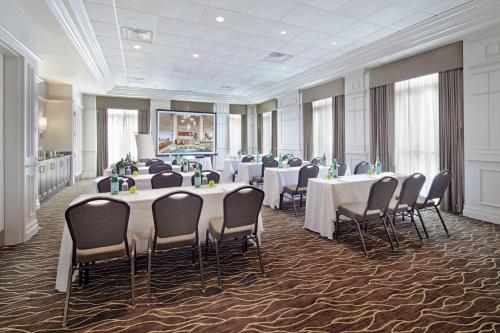 a conference room with tables and chairs in a building at Hilton Garden Inn Montreal Airport in Dorval