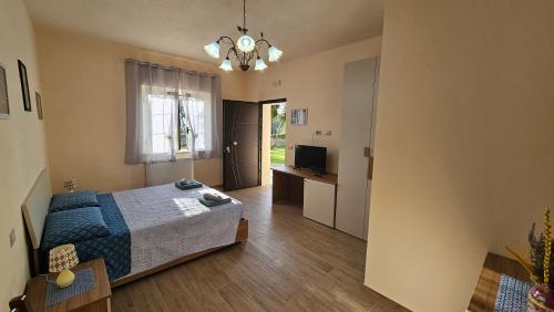 a bedroom with a bed and a television in it at B&B Nucria - Nocera Terinese in Nocera Terinese