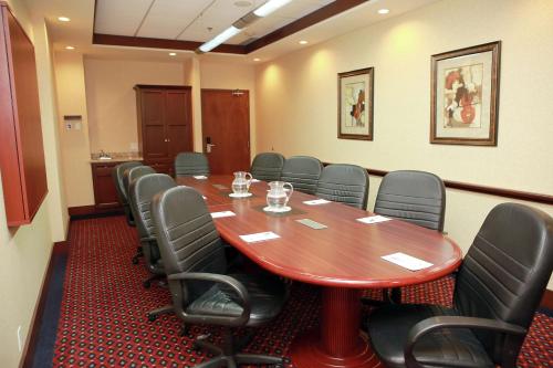 a conference room with a wooden table and chairs at Hampton Inn & Suites Laval in Laval