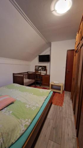 a bedroom with a large bed in a room at Room "Iva" in Josipdol