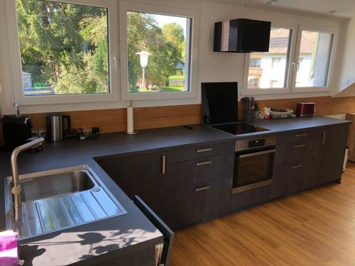 a kitchen with a sink and a counter top at Neue luxuriöse Ferienwohnung in ruhiger Lage in Leutkirch im Allgäu