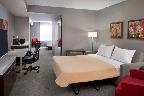 a hotel room with a bed and a desk at Hilton Garden Inn Toronto Airport West/Mississauga in Mississauga