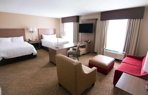 a hotel room with two beds and a desk at Hampton Inn & Suites Dallas/Frisco North-Fieldhouse USA in Frisco