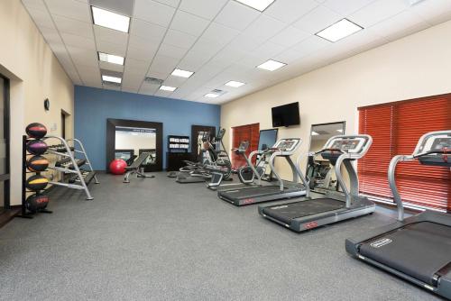 a gym with several exercise bikes and treadmills at Hampton Inn Kalamazoo in Kalamazoo