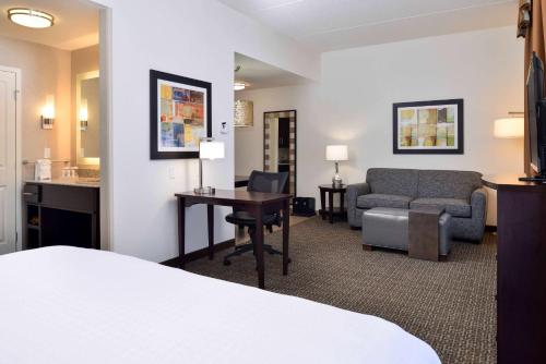 a hotel room with a bed and a desk and a couch at Homewood Suites by Hilton Columbia/Laurel in Laurel
