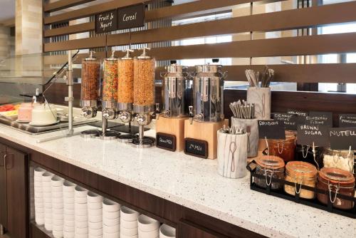 a counter in a restaurant with aasteryasteryasteryasteryasteryasteryasteryasteryastery at Embassy Suites by Hilton Chicago Naperville in Naperville
