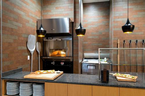 a kitchen with a counter with food on it at Embassy Suites Charlotte/Ayrsley in Charlotte