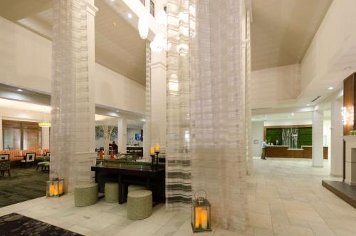 a lobby with a large column in a building at Hilton Garden Inn Hickory in Hickory