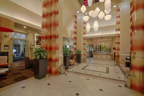 a lobby with potted plants in a building at Hilton Garden Inn Las Vegas Strip South in Las Vegas
