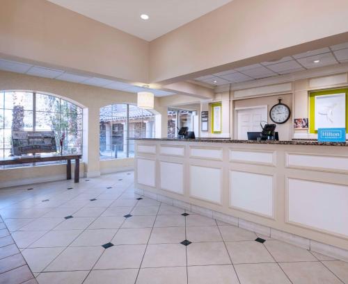 a lobby with a bar with a clock on the wall at Hilton Garden Inn Las Vegas Strip South in Las Vegas