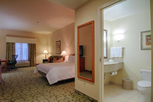 a hotel room with a bed and a bathroom at Hilton Garden Inn Las Vegas Strip South in Las Vegas