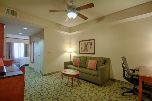 a living room with a couch and a table at Hilton Garden Inn Las Vegas Strip South in Las Vegas