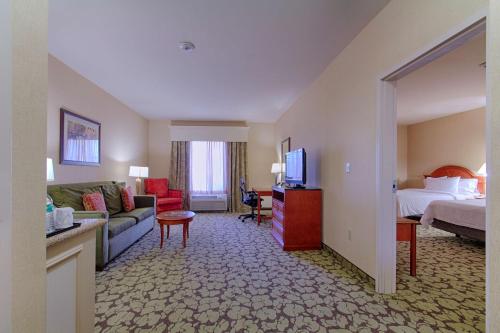 a hotel room with a bed and a living room at Hilton Garden Inn Las Vegas Strip South in Las Vegas
