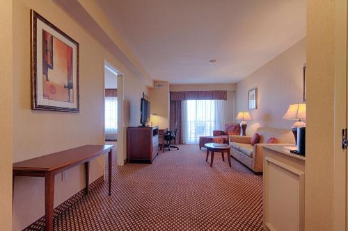 a hotel room with a living room with a couch and a table at Hilton Garden Inn Las Vegas Strip South in Las Vegas