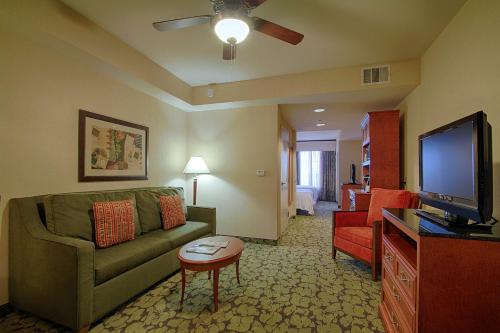 a living room with a couch and a flat screen tv at Hilton Garden Inn Las Vegas Strip South in Las Vegas