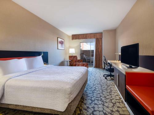a hotel room with a bed and a flat screen tv at Hilton Garden Inn Las Vegas Strip South in Las Vegas