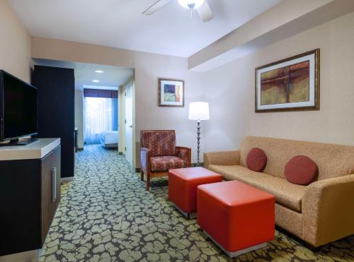 a living room with a couch and a tv at Hilton Garden Inn Las Vegas Strip South in Las Vegas