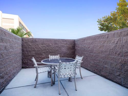 a patio with a table and chairs and a brick wall at Hilton Garden Inn Las Vegas Strip South in Las Vegas