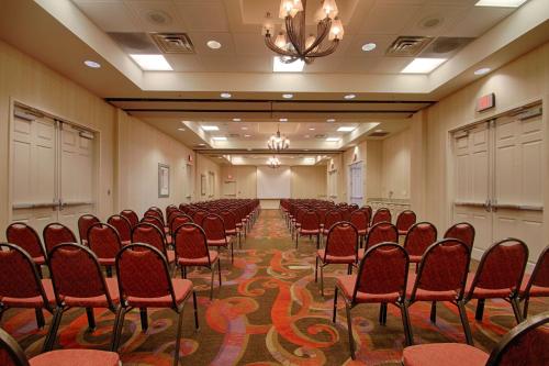 a conference room with red chairs and a chandelier at Hilton Garden Inn Las Vegas Strip South in Las Vegas