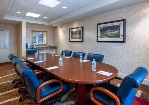 a conference room with a large wooden table and chairs at Hilton Garden Inn Las Vegas Strip South in Las Vegas