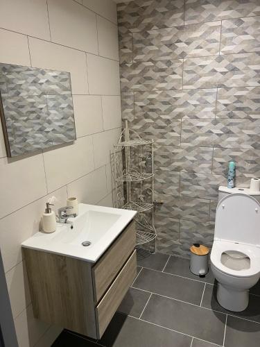 a bathroom with a sink and a toilet at la vallées du tuffeau in Bourré