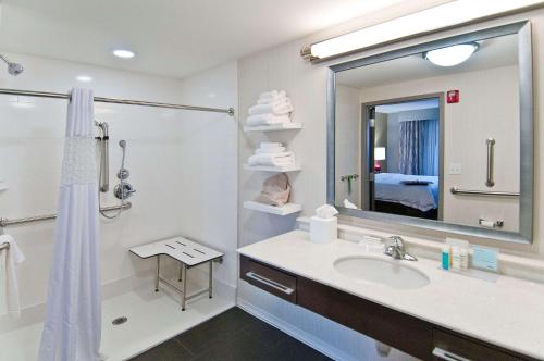 a bathroom with a sink and a shower and a mirror at Hampton Inn and Suites Pauls Valley in Pauls Valley