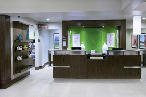 a lobby of a hospital with a green wall at Hilton Garden Inn San Antonio/Rim Pass Drive in San Antonio