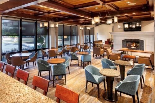 a restaurant with tables and chairs and a fireplace at DoubleTree by Hilton Ontario Airport in Ontario