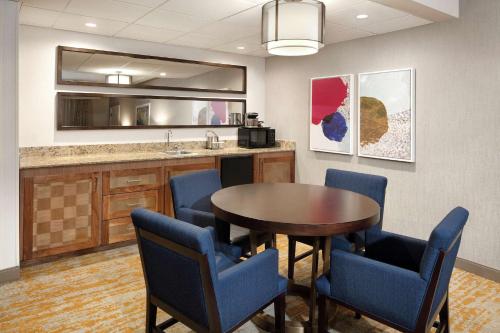 a conference room with a table and chairs and a counter at DoubleTree by Hilton Ontario Airport in Ontario