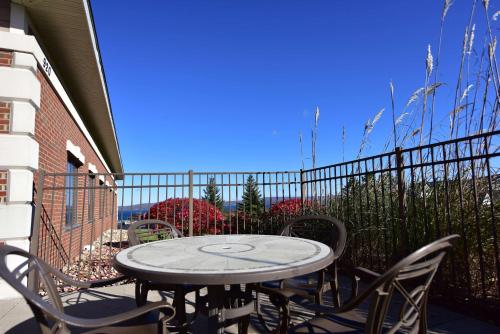 a patio with a table and chairs on a balcony at Hampton Inn & Suites Petoskey in Petoskey