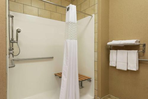 a bathroom with a shower with a white shower curtain at Hampton Inn Warsaw in Warsaw