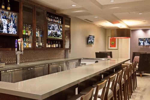 a bar with a long counter and chairs at Hilton Garden Inn Irvine/Orange County Airport in Irvine
