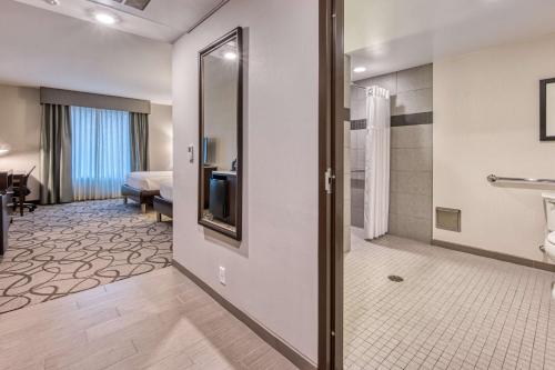 a hotel room with a bathroom with a shower at Hilton Garden Inn Irvine/Orange County Airport in Irvine