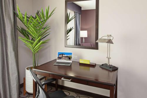 a desk with a laptop on it in a room at Hilton Garden Inn Irvine/Orange County Airport in Irvine