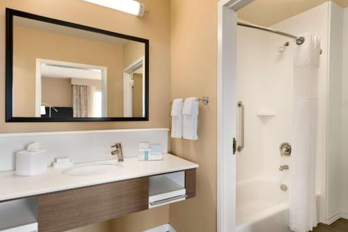 a bathroom with a sink and a mirror at Hampton Inn and Suites Monroe in Monroe
