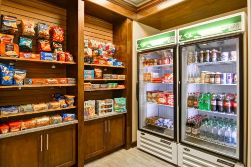 a grocery store with two refrigerators and food at Homewood Suites by Hilton Woodbridge in Woodbridge