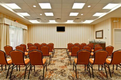 a conference room with a bunch of chairs and a podium at Homewood Suites by Hilton Woodbridge in Woodbridge