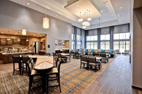 a restaurant with tables and chairs and a cafeteria at Homewood Suites by Hilton Cincinnati/West Chester in West Chester