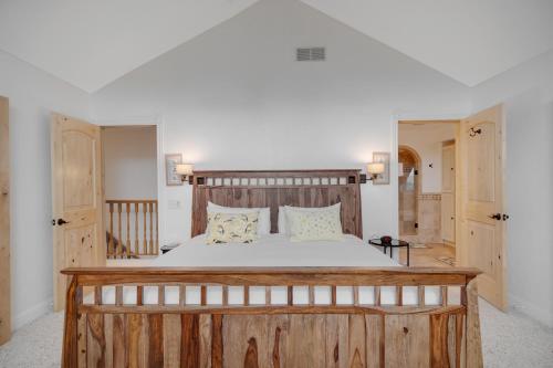 a bedroom with a large bed with a wooden headboard at Mountain Haven Retreat in Driggs
