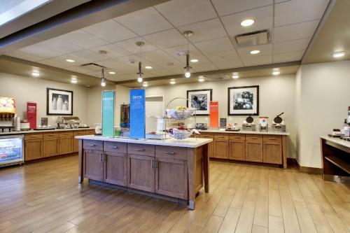 a large room with a counter in a pharmacy at Hampton Inn & Suites Milwaukee West in West Allis