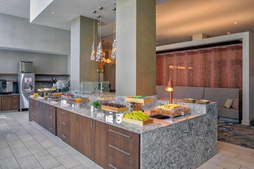 a buffet line with food on it in a hotel room at Hilton Norfolk The Main in Norfolk