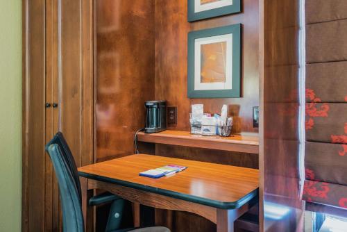 a wooden table in a restaurant with a small table with chairs at Hampton Inn Tampa International Airport/Westshore in Tampa