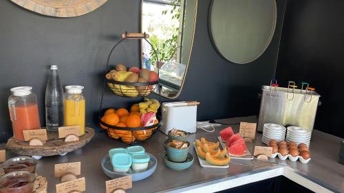 a counter with baskets of fruit and drinks on it at Poisson Rouge in Bonifacio